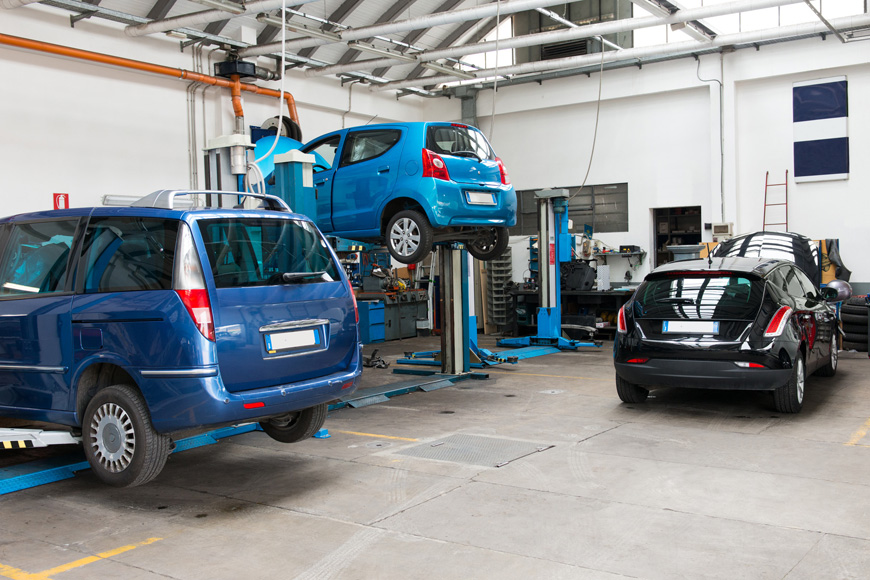 Cars being serviced in a fully equipped garage workshop